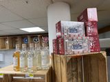 bottles of alcohol are stacked on top of wooden crates in a store