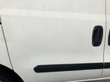 a white van with black trims parked in a parking lot