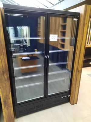 a refrigerator that has two glass doors in it