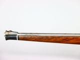 an old gun with a wooden handle on a white background