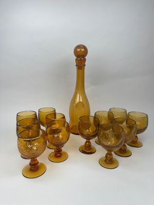 bottles and glasses are lined up on a white surface