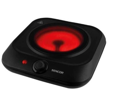 une plaque de cuisson noire et rouge, surmontée d'un voyant rouge