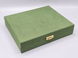 an empty green box with a gold handle on a white background