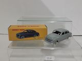 a toy car and a box on a white surface