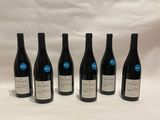 six bottles of wine are lined up in a row on a white background