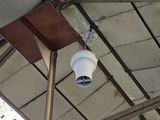 a camera mounted to the ceiling of a building