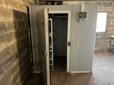 an open door in a room with a brick wall in the background