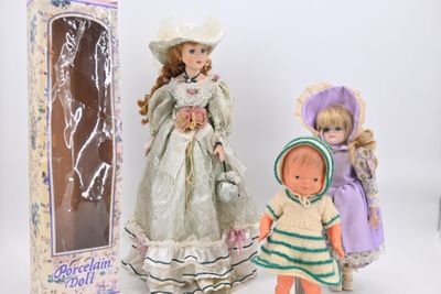 two dolls are standing next to each other in front of a box