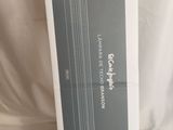 the box is open on a white surface with a black and white drawing of a tube