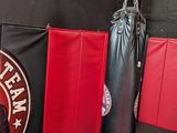 a black and red boxing bag next to a black and red punching bag