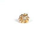 a close up of a gold ring with a diamond in it