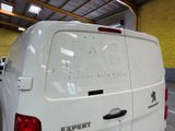 a white van parked inside of a building with a sign on the back