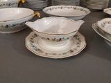 a lot of plates and bowls on the table