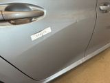 a close up of a car door handle with a sticker on it