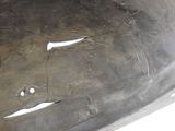 a close up of a piece of metal with holes in it