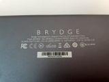 the back of a black laptop with a sticker that says brydge