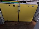 a yellow refrigerator sitting in the corner of a kitchen