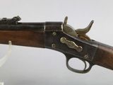 an old gun with a wooden barrel and brass fittings