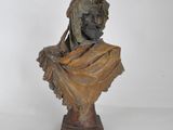 statue of a woman with a veil on her head on a pedestal