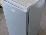 an image of a small refrigerator in a warehouse