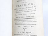 someone is holding a book with a handwritten title in front of a white background