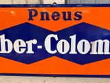 a large orange and blue sign that says preus barber colony