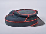 a hat with a red line on it on a white surface