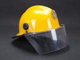 a close up of a yellow hard hat with a clear vise