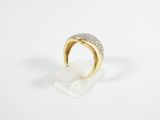 a gold and diamond ring on a clear acrylic stand