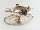 a silver plate with a bowl on it on a white surface