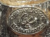 a silver coin sitting on top of a glass bowl