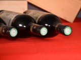 several bottles of wine are lined up on a red table