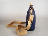 a blue bottle with a brown cord around it