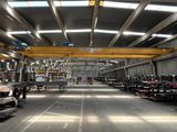a large warehouse with a lot of cars parked in it