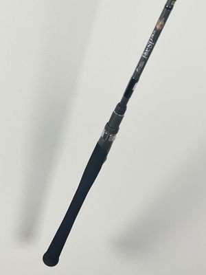 a close up of a fishing rod on a white surface