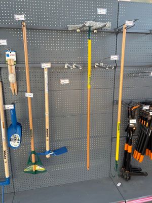 a lot of tools hanging on the wall in the store
