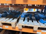 several blue pumps on a pallet in a warehouse