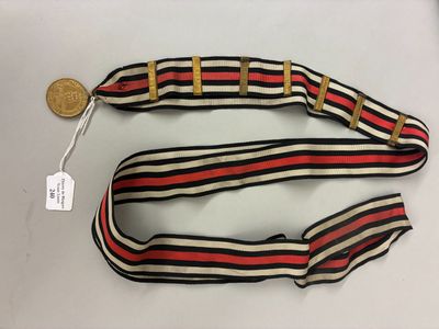 un gros plan d'une ceinture avec une pièce de monnaie posée sur une table