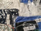 a lot of shirts that are wrapped in plastic bags