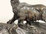 a statue of a goat that is standing on a rock
