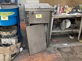 an image of a kitchen area with a trash can and a trash can