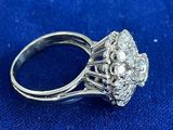 a close up of a diamond ring on a blue cloth