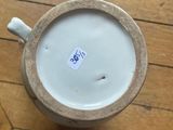 a cup that is sitting on a wooden floor
