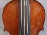 an old violin sitting on top of a table next to a wall