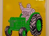 yellow and black sign with a picture of a man driving a tractor