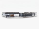 a black umbrella wrapped in a plastic bag on a white surface