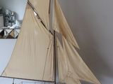 a small sailboat sitting on top of a wooden table