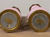 pair of pink and gold vases on a brown surface