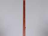an old fashioned wooden instrument on a stand on a white surface