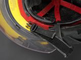 a close up of a fireman ' s helmet with a red and yellow stripe